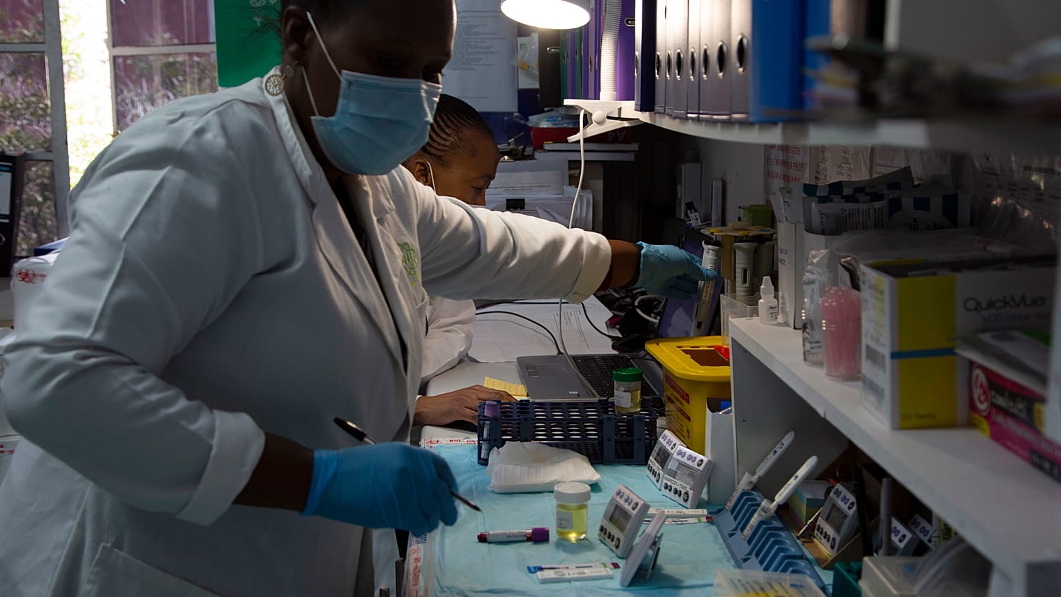 Laboratory technicians test a blood sample for HIV infection at the Reproductive Health and HIV Institute (RHI) in Johannesburg