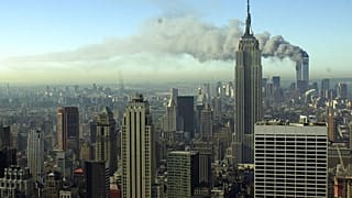Smoke billows across the New York City skyline after two hijacked planes crashed into the twin towers on Sept. 11, 2001.