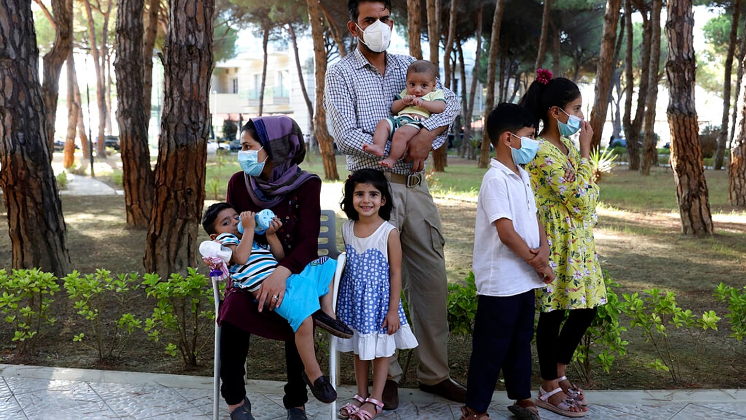 An Afghan family gather at a resort which is accommodated Afghan refugees in Golem, west of the capital Tirana.