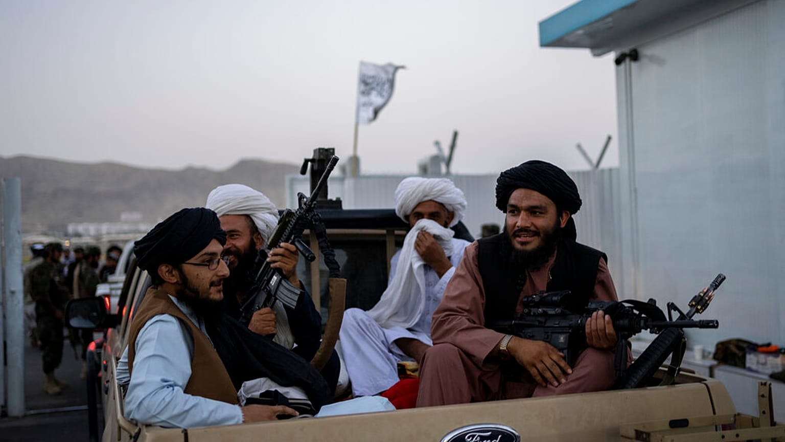 Taliban fighters sit in a pickup truck at the airport in Kabul, Afghanistan, Thursday, Sept. 9, 2021. 