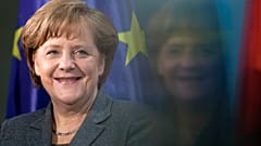 Chancellor Angela Merkel smiles during the presentation of a special edition of a two Euro coin at the chancellery in Berlin, Germany, on 9 February 2012.