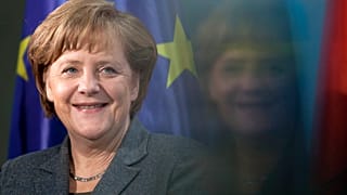 Chancellor Angela Merkel smiles during the presentation of a special edition of a two Euro coin at the chancellery in Berlin, Germany, on 9 February 2012.