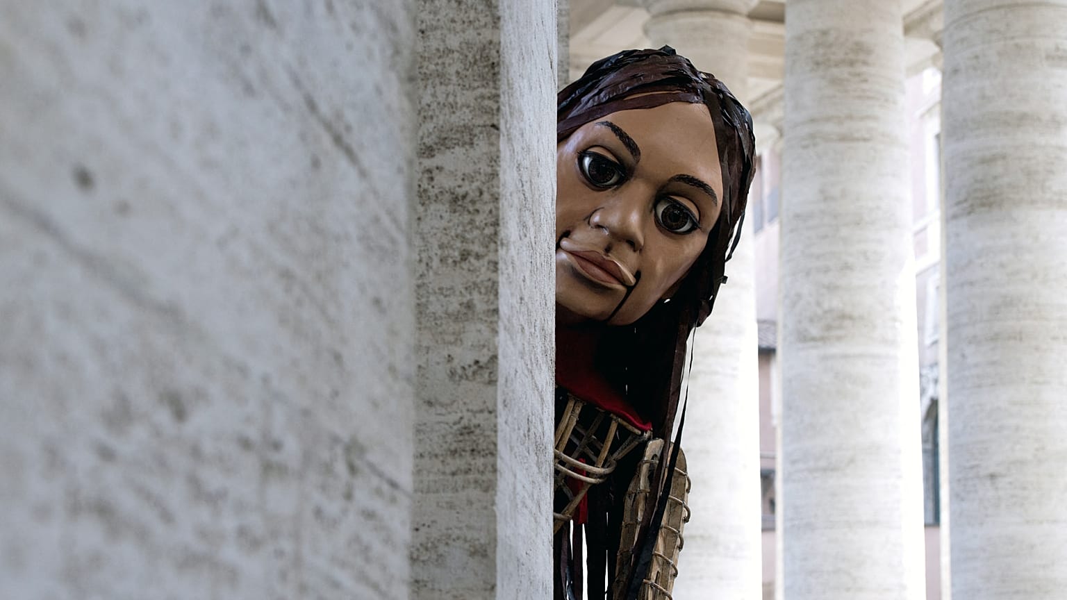 A giant puppet - called Little Amal - depicting a young Syrian refugee girl arrives at St. Peter's square in the Vatican.