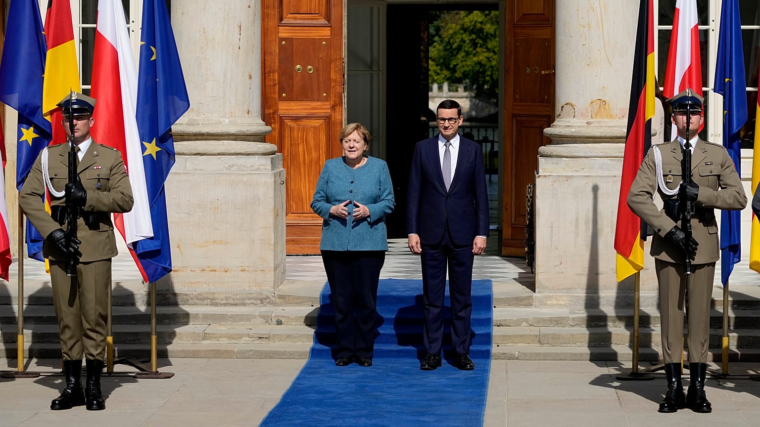 German Chancellor Angela Merkel, left, meets Poland's Prime Minister Mateusz Morawiecki in Warsaw, Poland, Saturday, Sept.11, 2021.