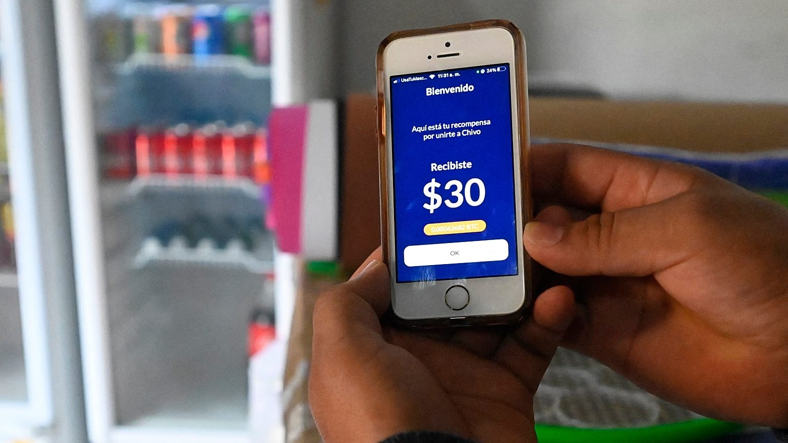A person shows a screen while using the Salvadoran government's electronic wallet Chivo, after bitcoins were put into circulation throughout the country.