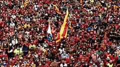 People wave Catalan pro-independence "Estelada" flags during a demonstration marking the "Diada", national day of Catalonia, in Barcelona on September 11, 2021.