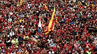 People wave Catalan pro-independence "Estelada" flags during a demonstration marking the "Diada", national day of Catalonia, in Barcelona on September 11, 2021.