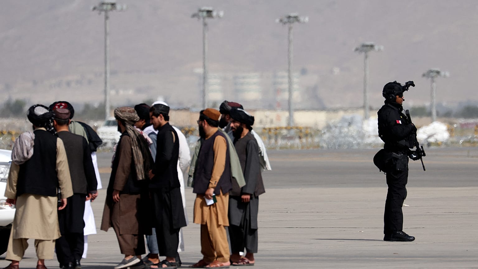 A member of the Qatar special forces (R) stands guard as he arrives at the airport in Kabul on September 12, 2021.