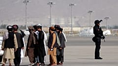 A member of the Qatar special forces (R) stands guard as he arrives at the airport in Kabul on September 12, 2021.