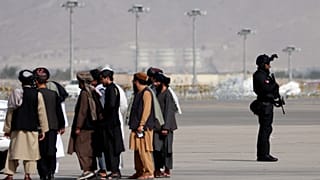 A member of the Qatar special forces (R) stands guard as he arrives at the airport in Kabul on September 12, 2021.