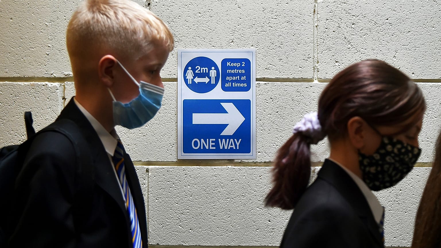 Pupils line up at a Covid test station as they enter their new secondary school for the first time at Wales High school, Sheffield, England, Sept. 3, 2021.