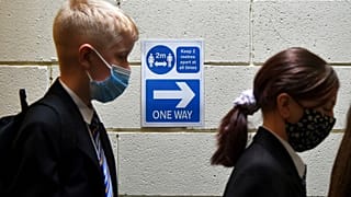 Pupils line up at a Covid test station as they enter their new secondary school for the first time at Wales High school, Sheffield, England, Sept. 3, 2021.