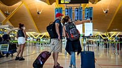Passengers check the departure screen at Adolfo Suarez-Barajas airport in Madrid, Spain, July 9, 2021.