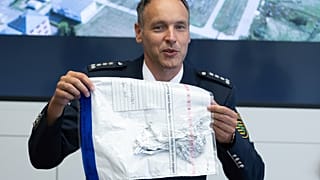 Police spokesman Thomas Geithner shows the remains of the metal foil of the balloon.