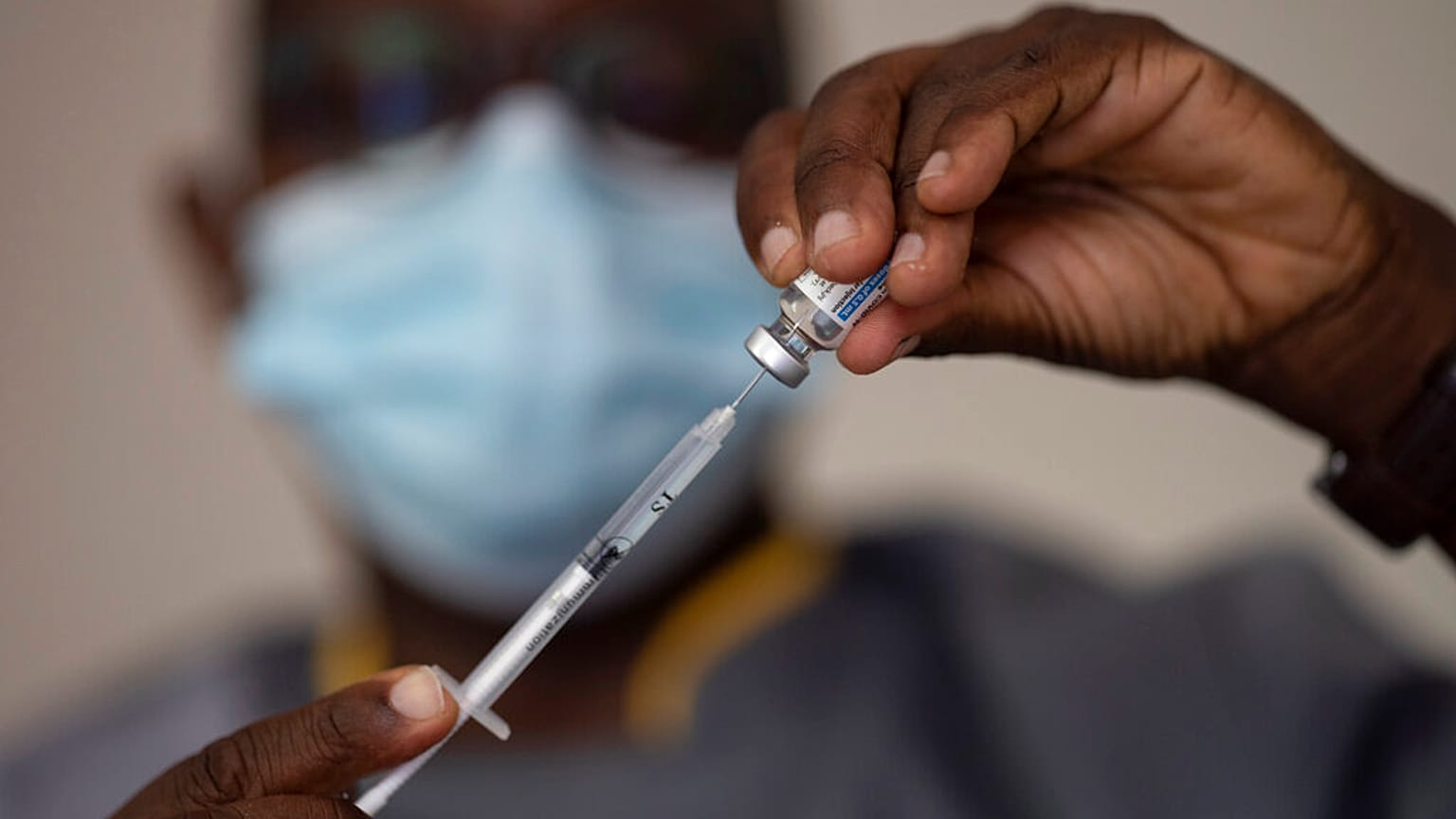 In this Wednesday, July 28, 2021 file photo, a health worker administers a dose of Janssen COVID-19 vaccine by Johnson & Johnson in the Medina neighborhood in Dakar, Senegal. 