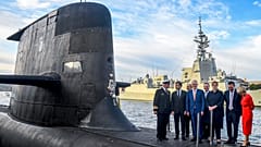 French President Emmanuel Macron (2/L) and then Australian Prime Minister Malcolm Turnbull (C) on HMAS Waller, an Australian Royal Navy submarine, Sydney, May 2, 2018.