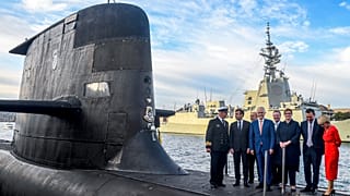 French President Emmanuel Macron (2/L) and then Australian Prime Minister Malcolm Turnbull (C) on HMAS Waller, an Australian Royal Navy submarine, Sydney, May 2, 2018.