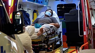 A man lays in an ambulance at the emergency service of the hospital in Papeete, Tahiti island, French Polynesia, Aug.20, 2021.