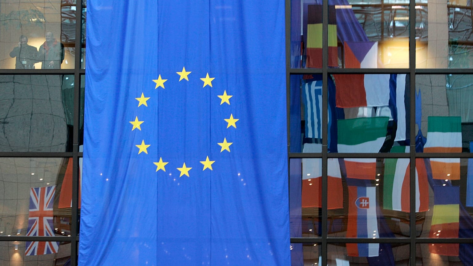 FILE: EU nations flags are mirrored in the windows of the EU Council headquarters ahead of a two-day EU summit in Brussels in March 2008