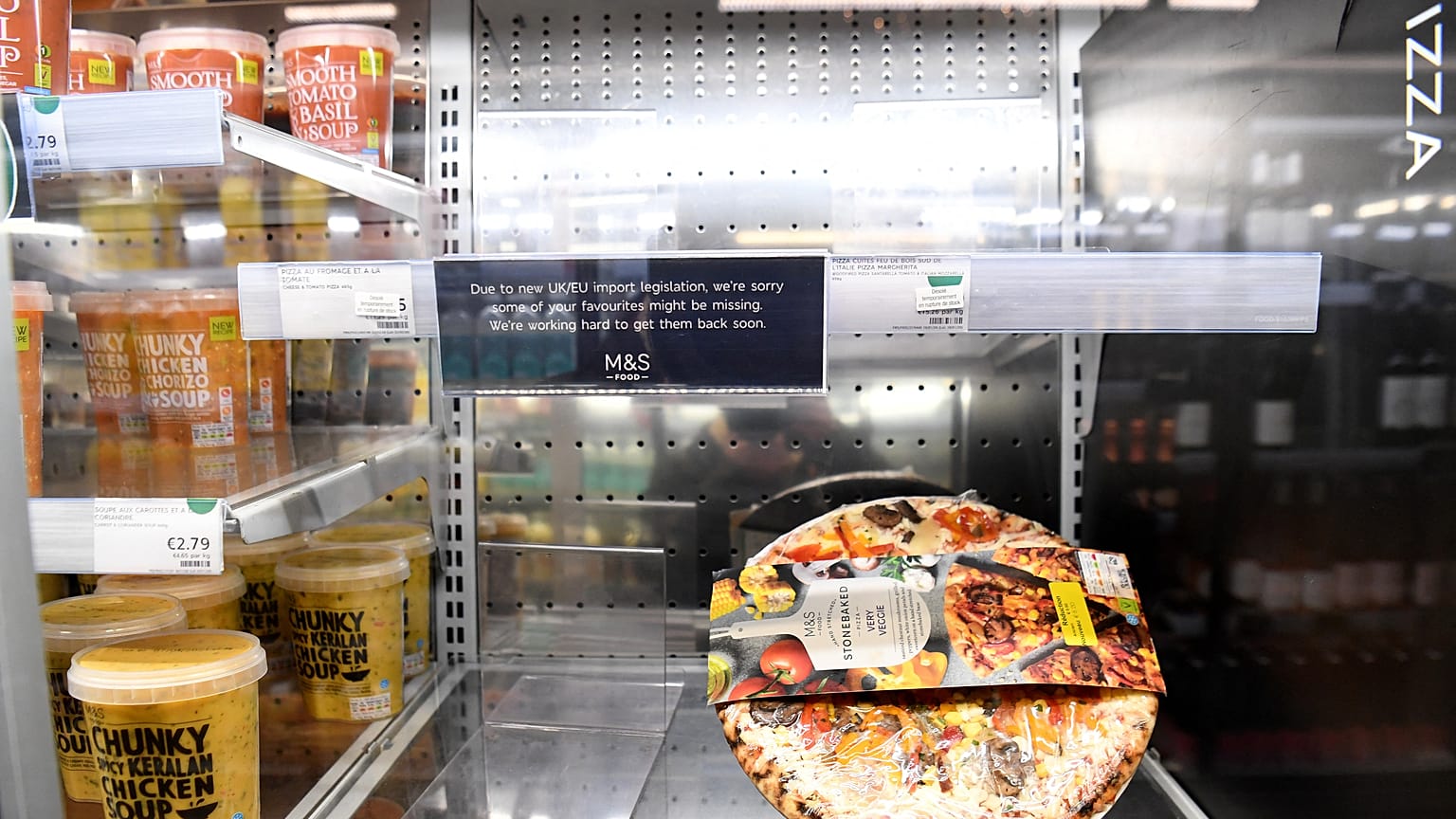 This picture taken on January 5, 2021 shows empty shelves at the M&S (Marks & Spencer) store in Paris. Fans of British fare in France have suffered an unsavoury Brexit shock.