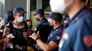 olice officers check passenger's documents at the entrance of Porta Garibaldi train station, in Milan, Italy, Wednesday, Sept. 1, 2021