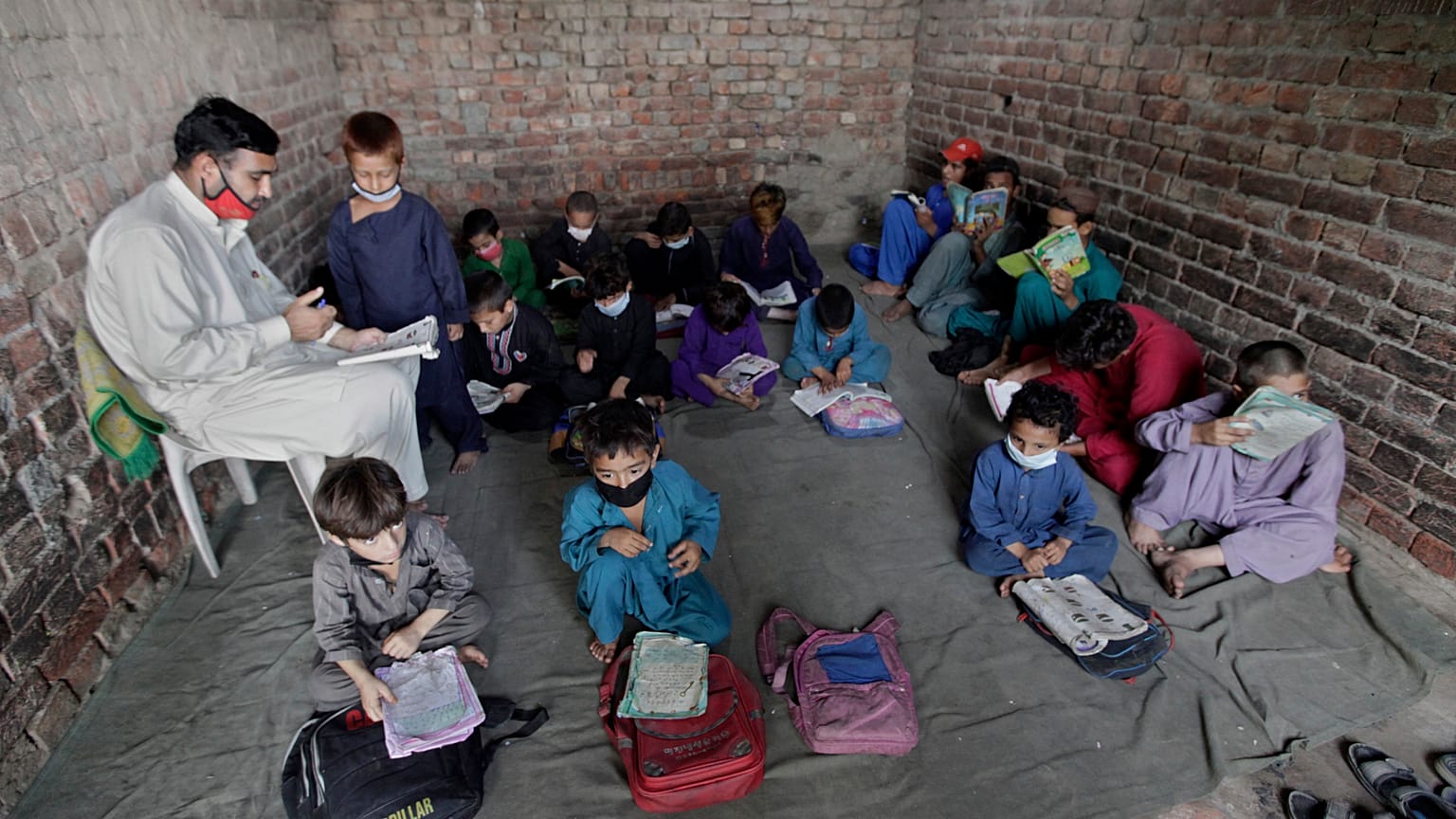 Afghan refugee children attend a class on the outskirts of Lahore, Pakistan.