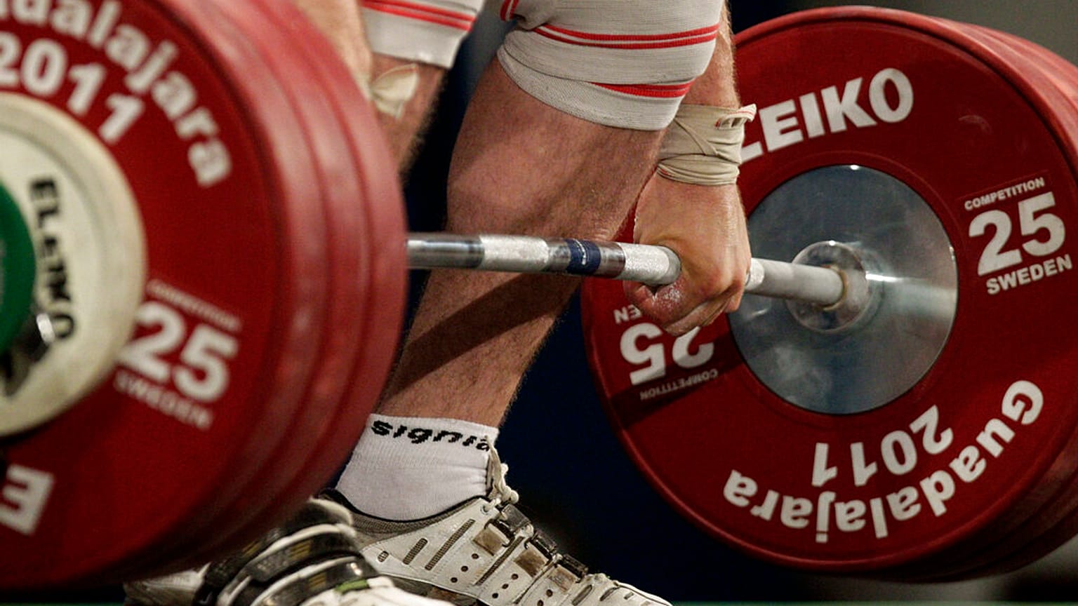 An athelete lifts 185 kg in the clean and jerk of a men's 105 kg weightlifting competition. 