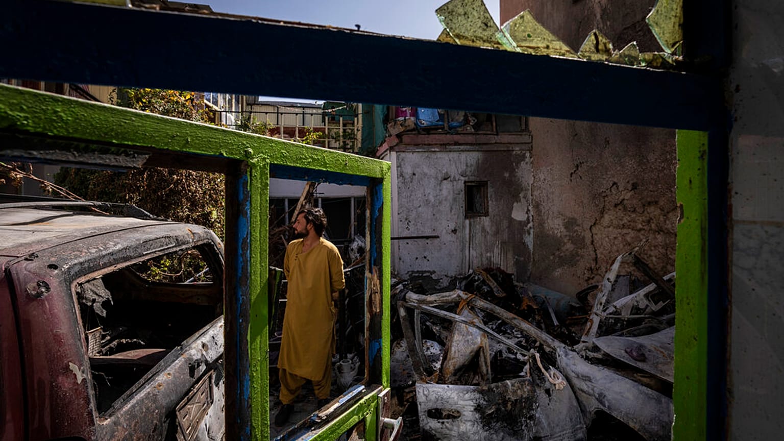 An Afghan inspects the damage of Ahmadi family house in Kabul, Afghanistan, Monday, Sept. 13, 2021. 