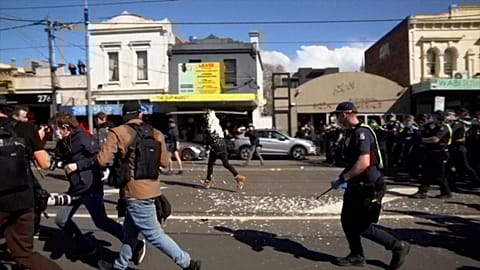 Protester getting pepper sprayed by police officer in Melbourne.