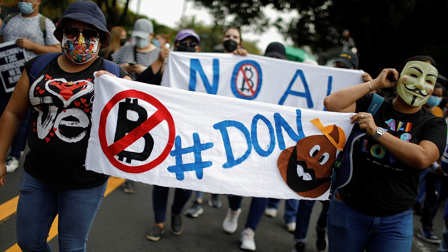People take part in a protest against the use of Bitcoin as legal tender and legal reforms to extend president Nayib Bukele's term in San Salvador, September 15, 2021.