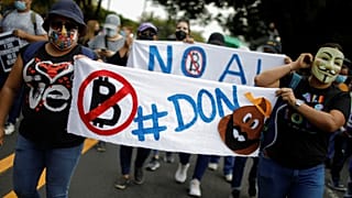 People take part in a protest against the use of Bitcoin as legal tender and legal reforms to extend president Nayib Bukele's term in San Salvador, September 15, 2021.