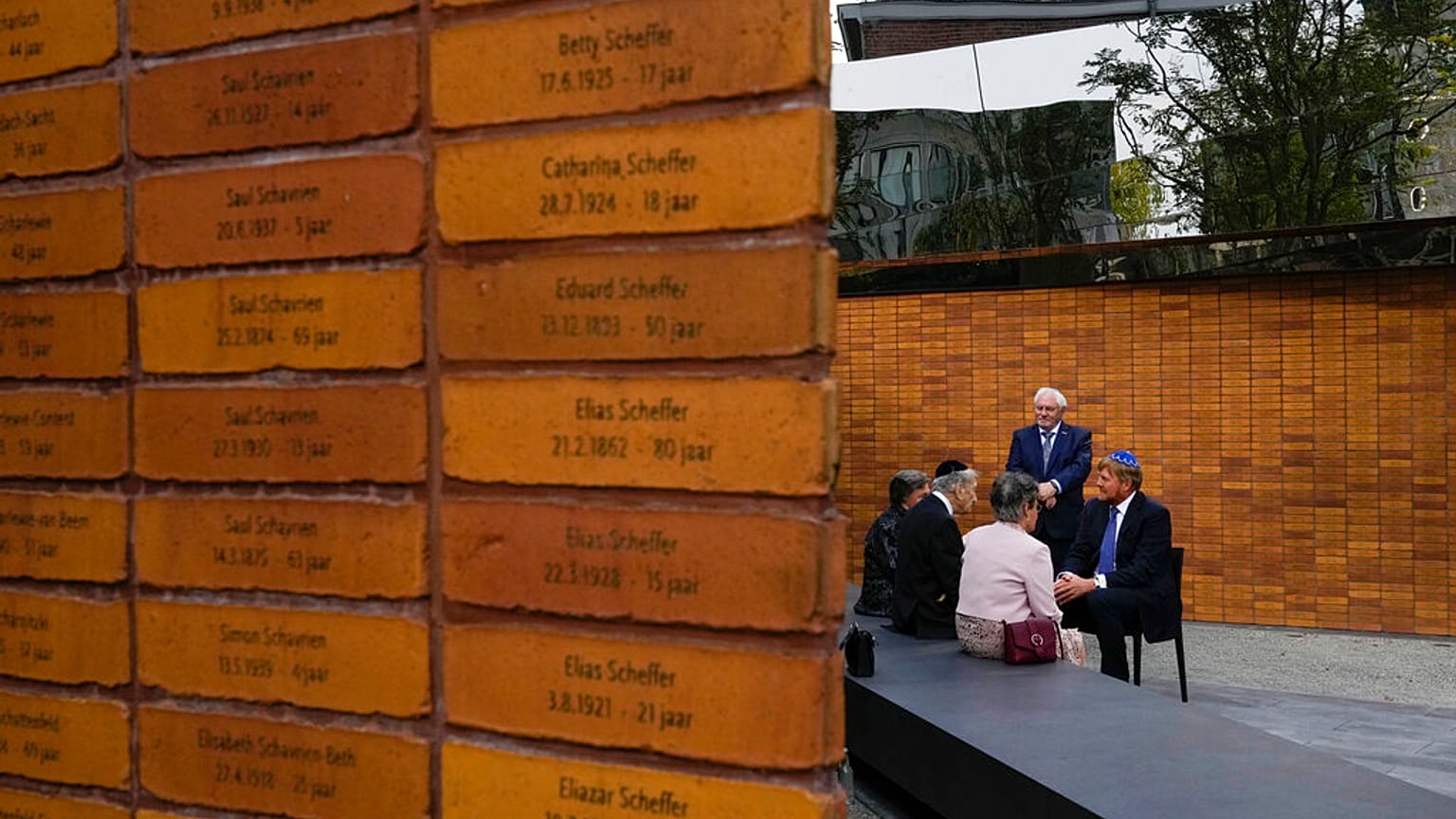  King Willem-Alexander, right, talks to Holocaust survivors and relatives after unveiling the new monument in Amsterdam's historic Jewish Quarter 