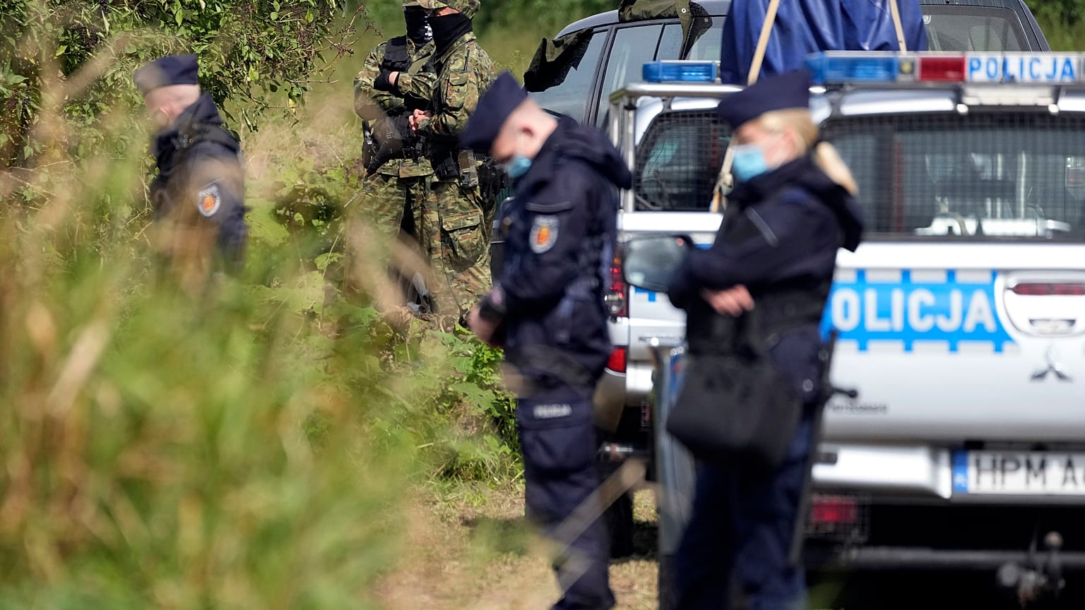 Polish forces stand guard in an area near the border with Belarus in Usnarz Gorny, Poland, on Wednesday, Sept. 1, 2021.