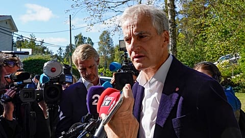 Norway’s Labor Party leader Jonas Gahr Store answers questions from reporters outside his home in Oslo.