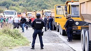 Kosovo special police stand on the road near the northern Kosovo border crossing of Jarinje.