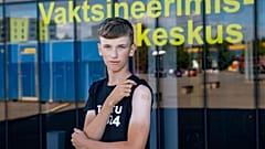 Joonas Leis , 12 years old boy, poses for a photo after getting a shot a coronavirus vaccine at a vaccination center inside a sports hall in Estonia.