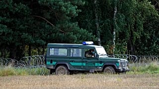 Polish border guards monitor an area along the border with Belarus in Usnarz Gorny, Poland.