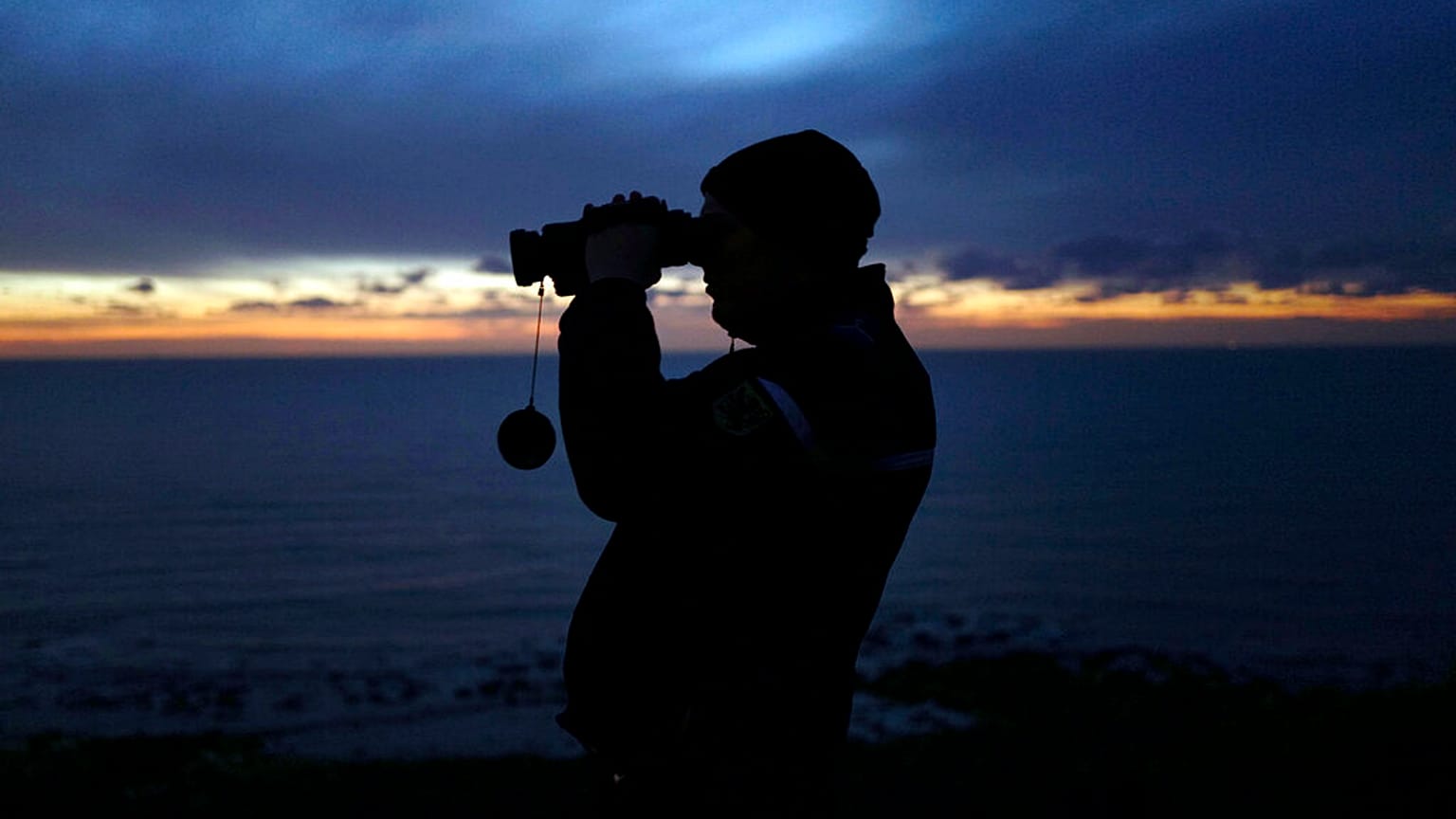 In this file photo dated Friday, Jan. 18, 2019, a French gendarme patrols the beach in Ambleteuse near Calais, northern France