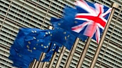 A Friday, Jan. 29, 2016 photo from files showing the British, right, and EU flags flapping in the wind outside of EU headquarters in Brussels.