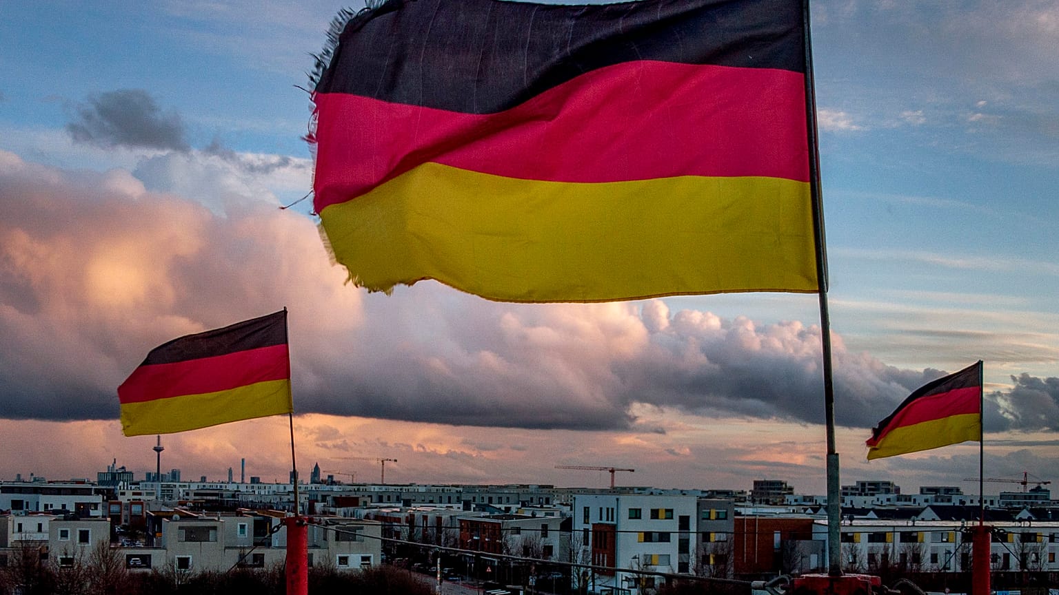 German flags wave in the wind on poles of a small circus in Frankfurt, Germany, Saturday, March 13, 2021.