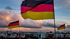 German flags wave in the wind on poles of a small circus in Frankfurt, Germany, Saturday, March 13, 2021.