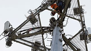 An operator performs maintenance on a phone masts, May 22, 2017 in High Ridge, Mo.