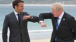 Britain's Prime Minister Boris Johnson, right greets French President Emmanuel Macron prior to the Leaders official welcome and group photo session, during the G7 summit