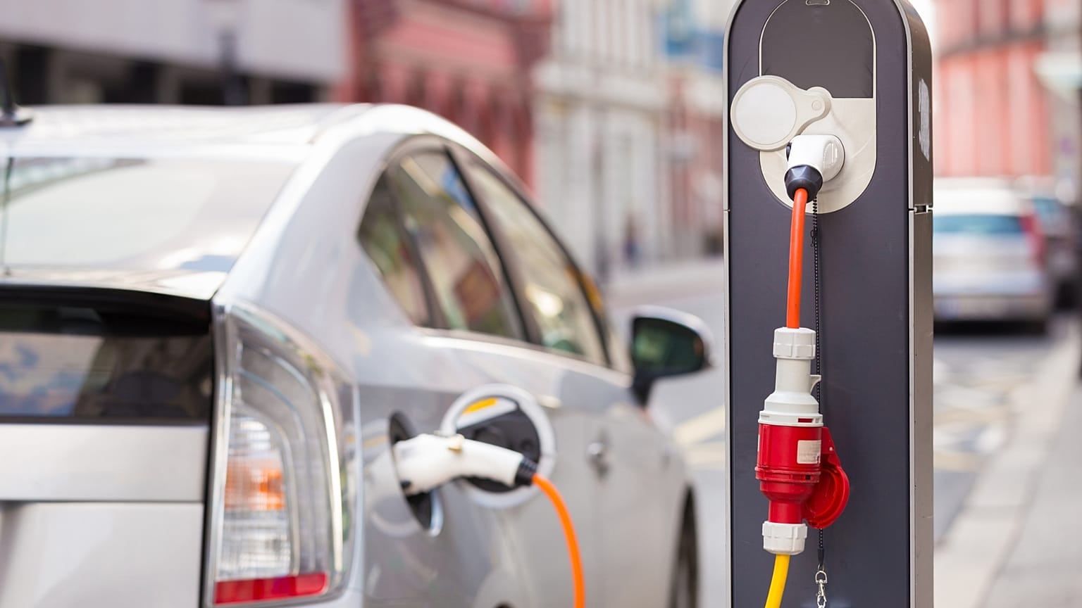 Toyota Prius connected to a charging station.