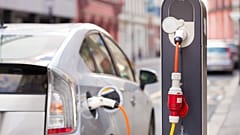Toyota Prius connected to a charging station.