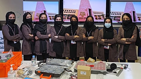 Members of an all-girl Afghan robotics team pose for a picture at the laboratory of Qatar's Texas A&M university in the capital Doha