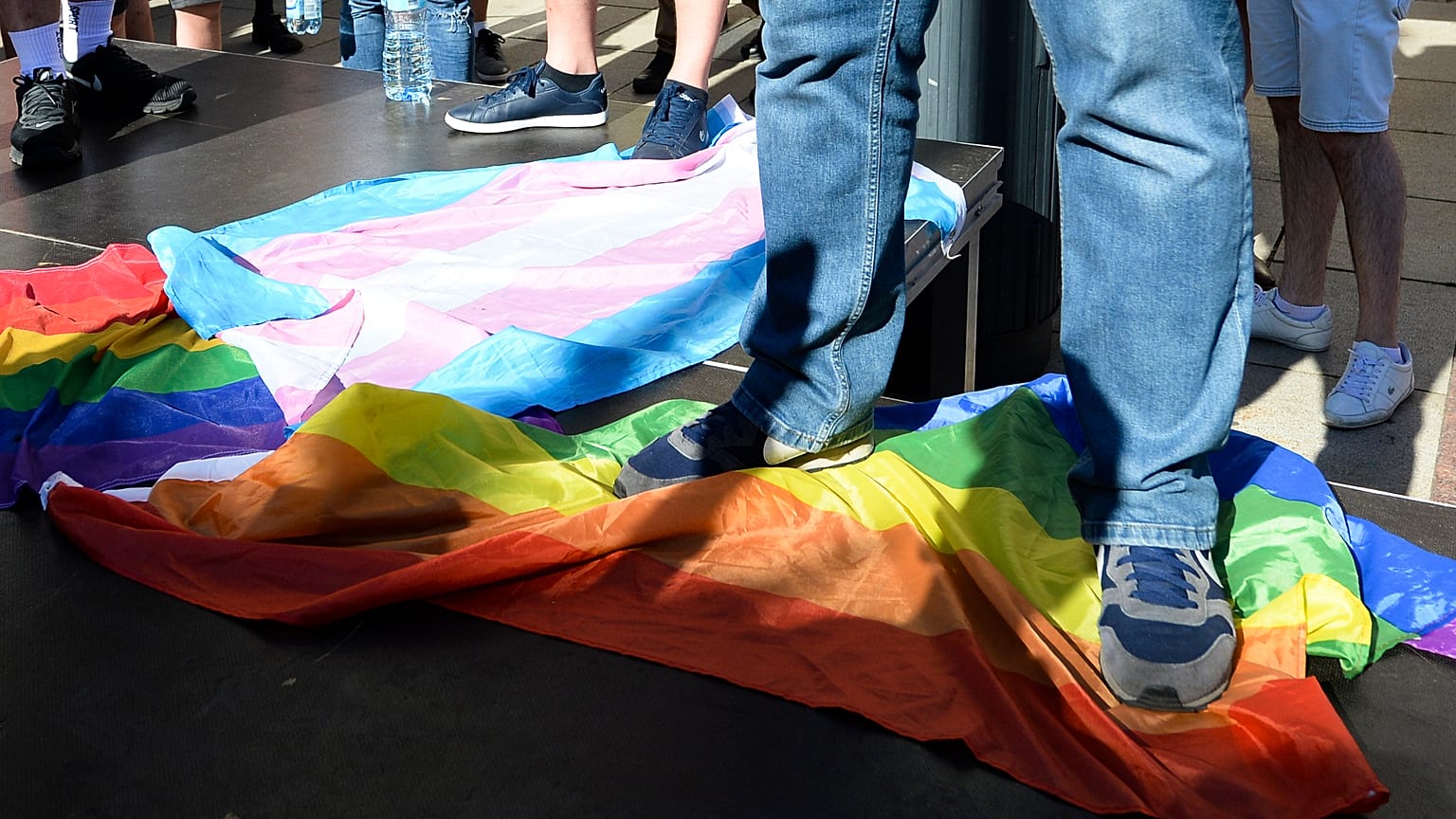 A man stands on a rainbow flag at a far-right rally against LGBT rights in Warsaw.