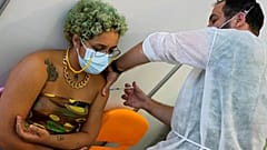 A military nurse inoculates Eduarda, from Brazil, with the Pfizer coronavirus vaccine at a vaccination center in Lisbon, Tuesday, Sept. 21, 2021