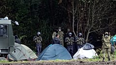 Polish security forces surround migrants stuck along with border with Belarus in Usnarz Gorny.