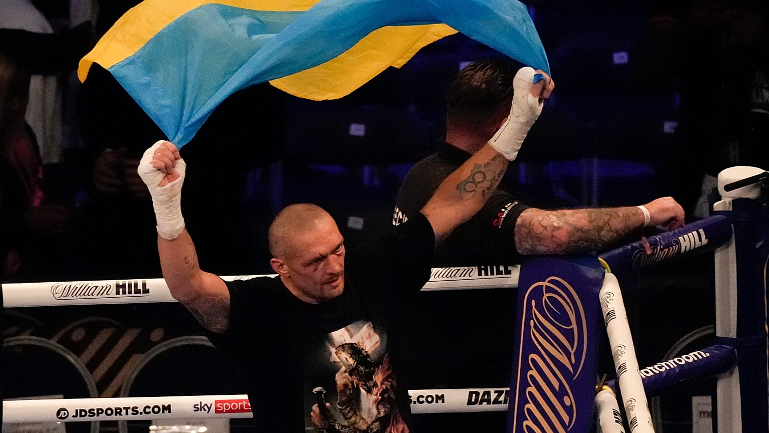 Oleksandr Usyk of Ukraine holds up the Ukrainian flag after his unanimous decision victory over Anthony Joshua of Britain, in London, Sept. 25, 2021.